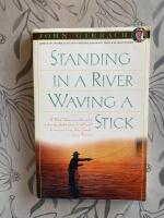 Standing in a river Waving a stick