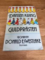 Dansen kring guldpr&auml;sten : [roman]