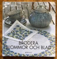 Brodera blommor och blad
